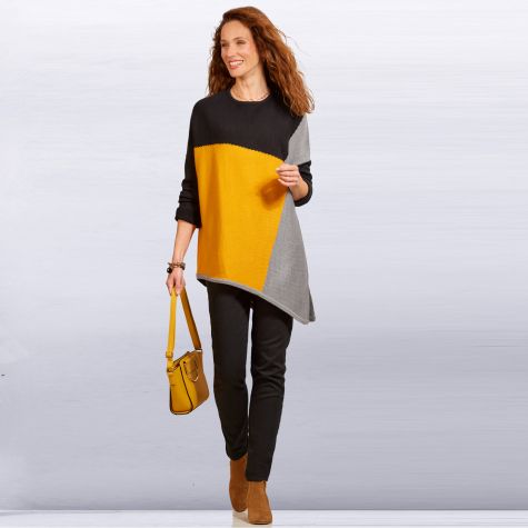 Pull-tunique asymétrique sur pantalon slim et bande à clou